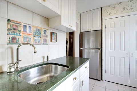 a kitchen with refrigerator a sink and cabinets