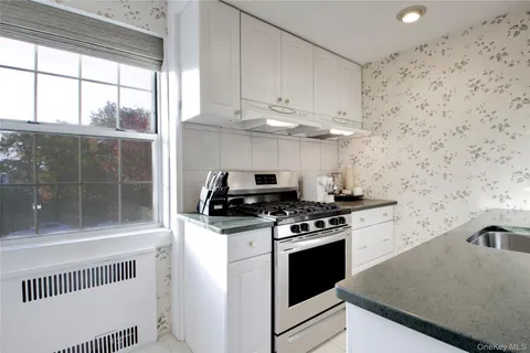 a kitchen with granite countertop a stove a sink and a granite counter tops