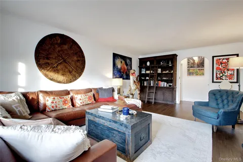 a living room with furniture and painting on the wall