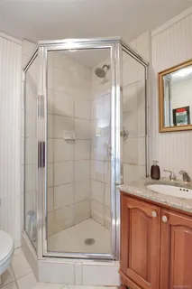 a bathroom with a shower and a sink a mirror