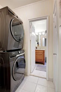 a bathroom with a sink a mirror and a washer