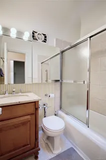 a bathroom with a toilet a sink and shower