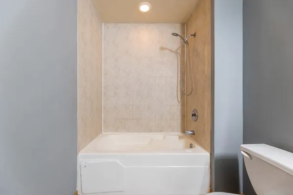 a bathroom with a tub and a shower