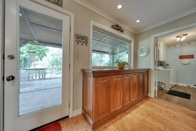 a view of a hallway and a livingroom with furniture