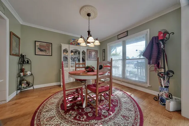 a living room with furniture a window and a chandelier
