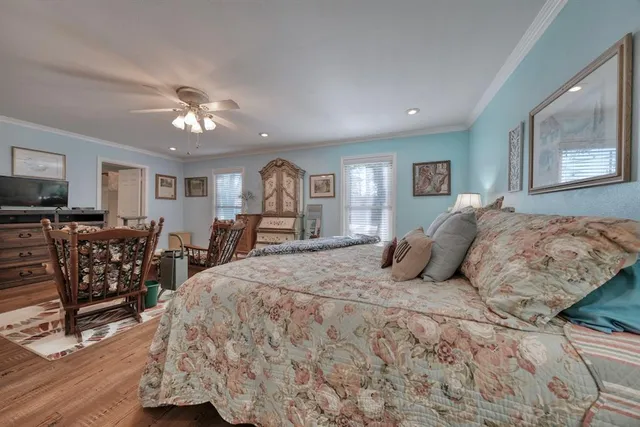 a bedroom with furniture a bed and a flat screen tv