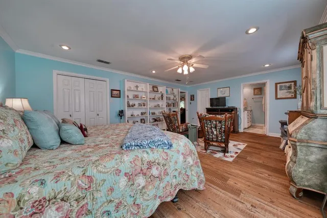 a spacious bedroom with a bed a table and chair