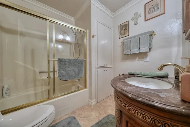 a bathroom with a granite countertop sink a mirror a bathtub and shower