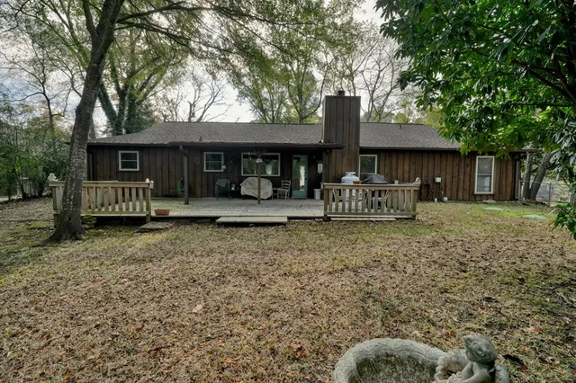 a front view of house with a garden
