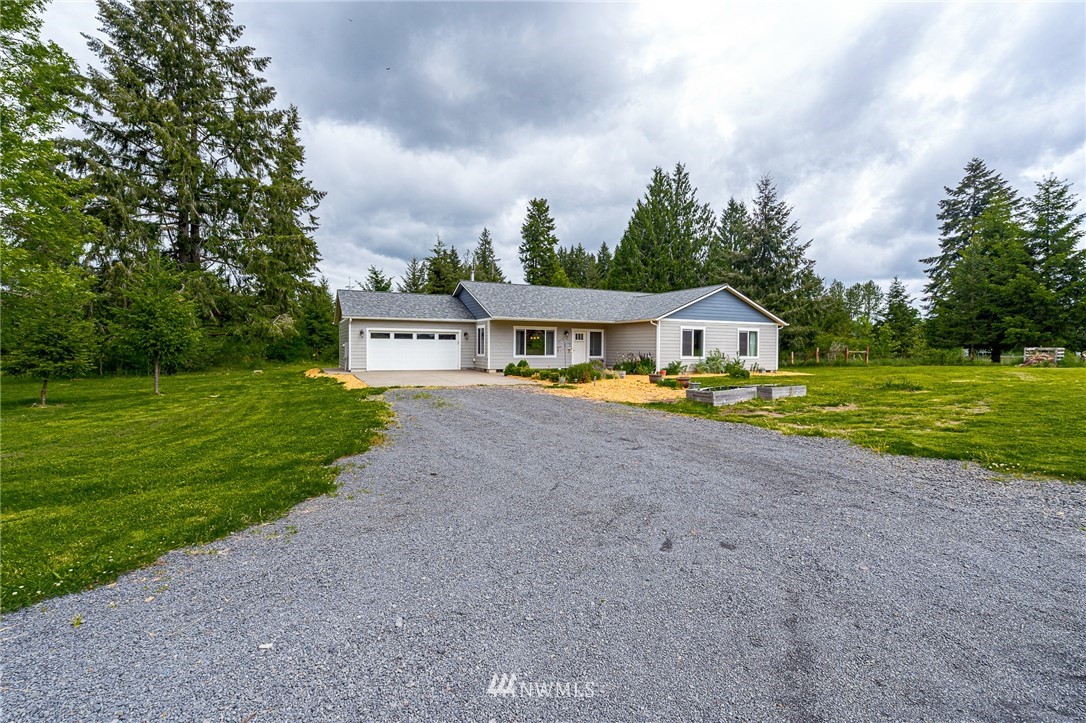 665 Rhoades Road Winlock, WA 98596 - Photo 2 of 39 a house with swimming pool in front of it