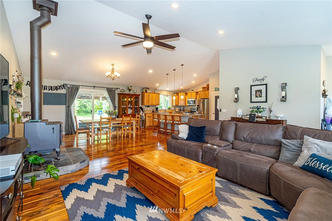 665 Rhoades Road Winlock, WA 98596 - Photo 14 of 39 a living room with furniture a ceiling fan and a window