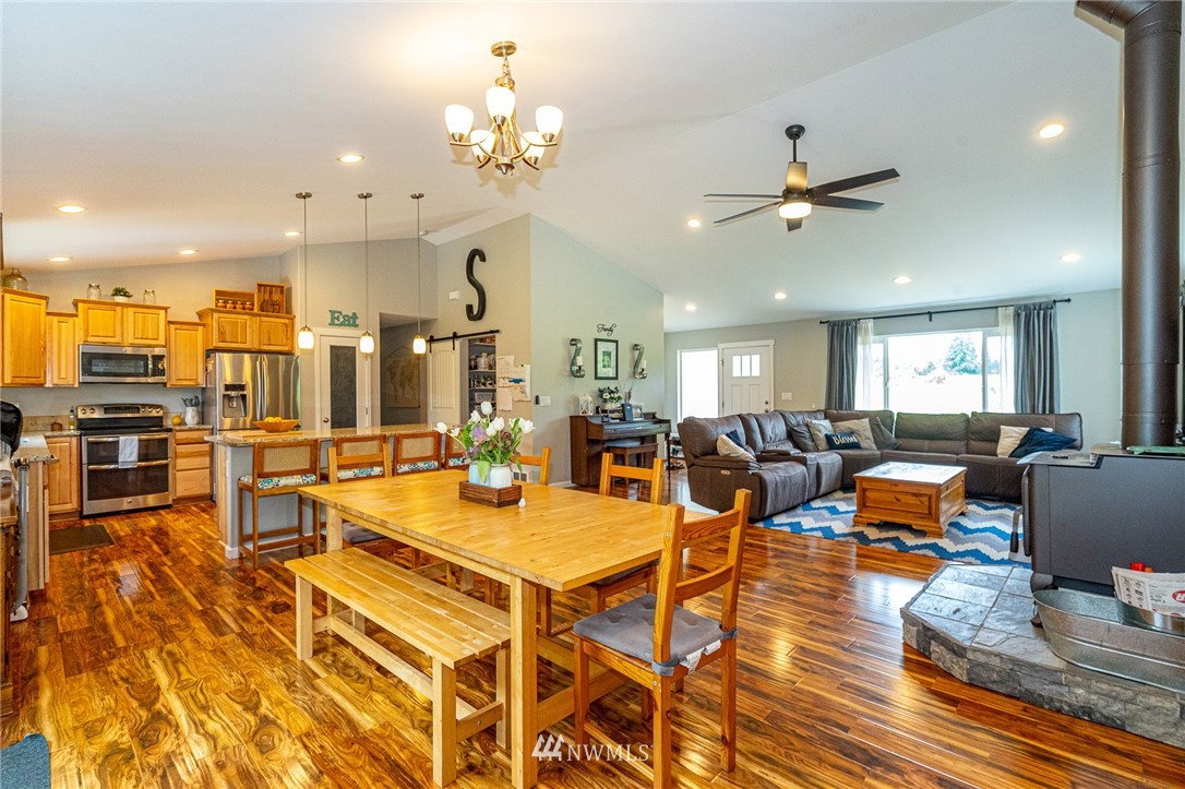 665 Rhoades Road Winlock, WA 98596 - Photo 15 of 39 a living room with lots of furniture kitchen view and a chandelier