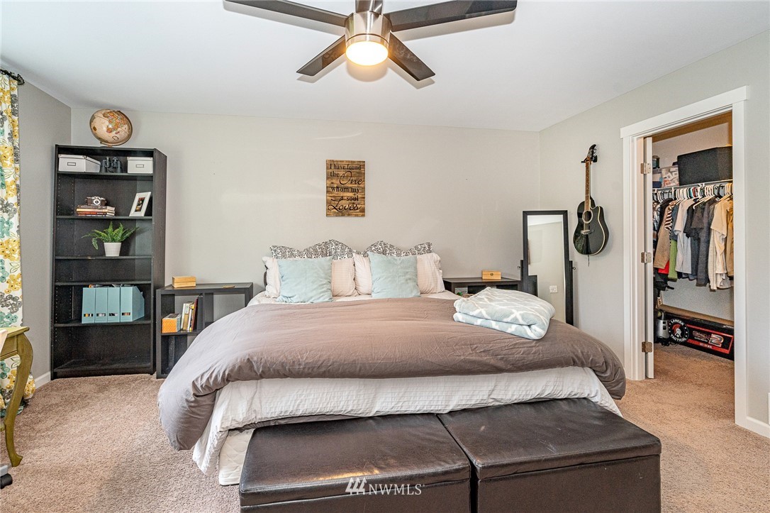 665 Rhoades Road Winlock, WA 98596 - Photo 17 of 39 a bedroom with a bed and a chandelier