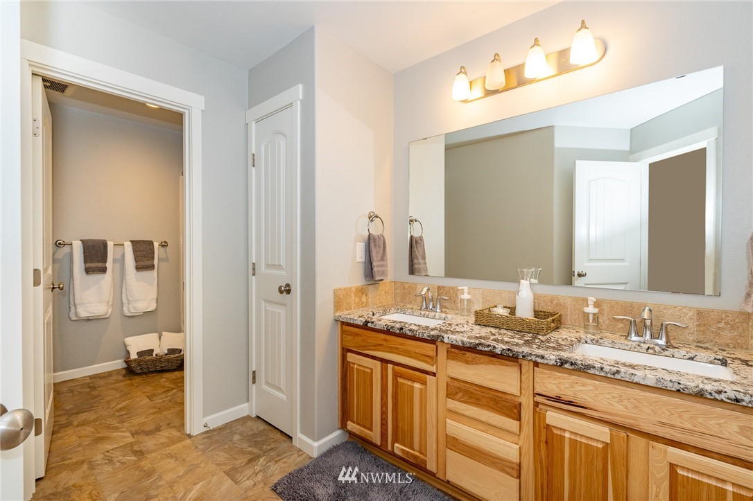 665 Rhoades Road Winlock, WA 98596 - Photo 19 of 39 a bathroom with a granite countertop sink and a mirror