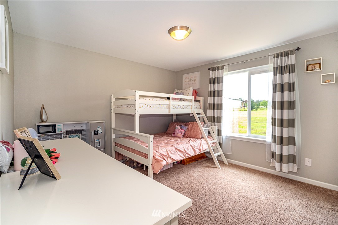 665 Rhoades Road Winlock, WA 98596 - Photo 21 of 39 a bedroom with a bed and a window