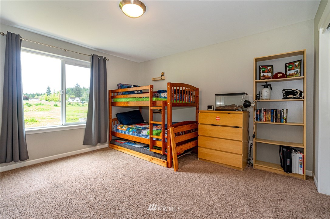 665 Rhoades Road Winlock, WA 98596 - Photo 23 of 39 a bedroom with bed and a window