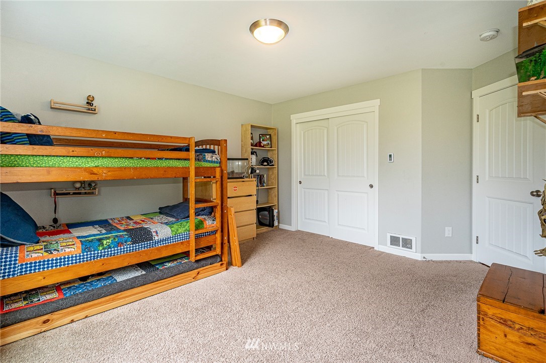 665 Rhoades Road Winlock, WA 98596 - Photo 24 of 39 a bedroom with bed and a window