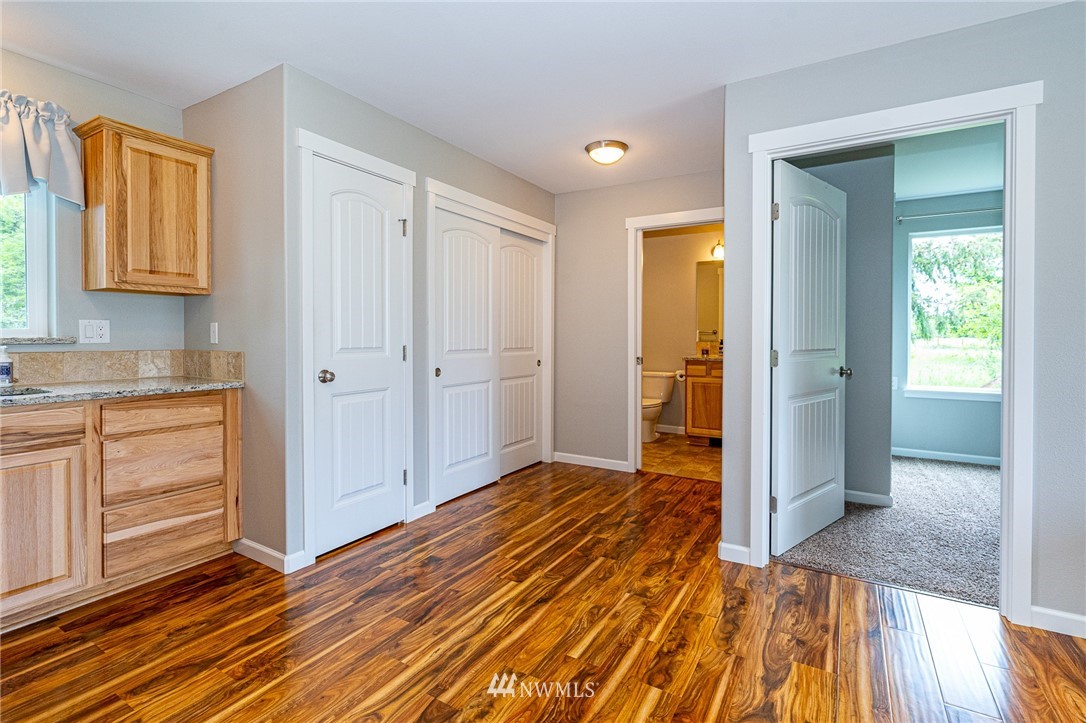665 Rhoades Road Winlock, WA 98596 - Photo 27 of 39 workspace with wooden floor and closet
