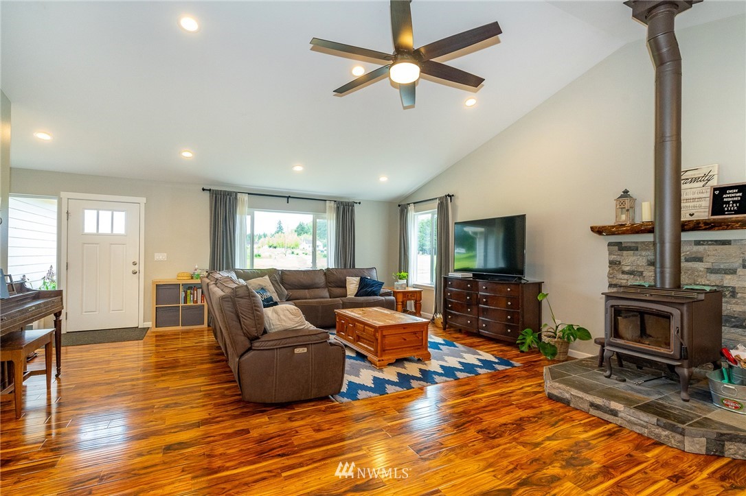 665 Rhoades Road Winlock, WA 98596 - Photo 4 of 39 a living room with furniture flat screen tv and wooden floor