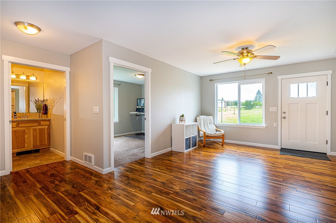 665 Rhoades Road Winlock, WA 98596 - Photo 31 of 39 a view of an empty room with window and wooden floor