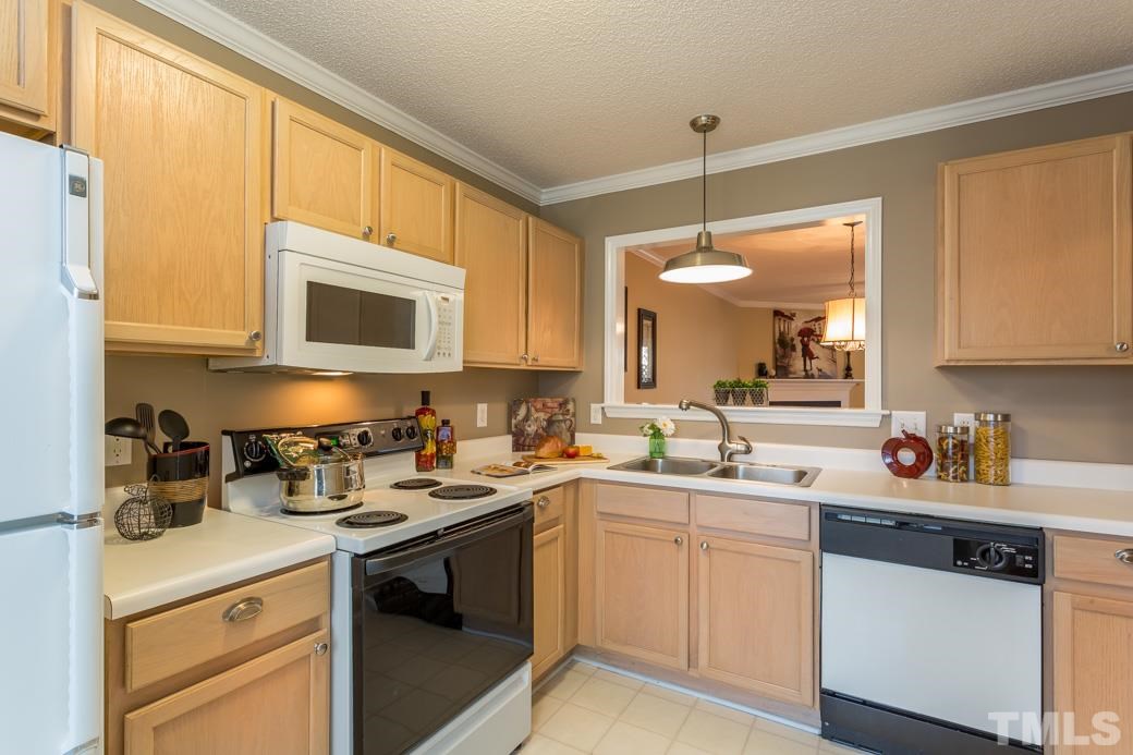 4416 Antique Lane Raleigh, NC 27616 - Photo 2 of 10 Kitchen with DESIGNER NEUTRAL color and UPDATED hardware!Ice maker in the freezer, and a pass through to the dining area!