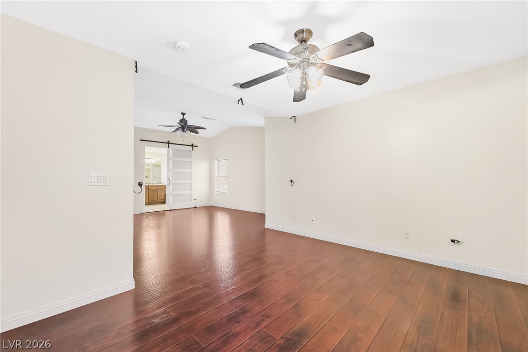 5905 Crumbling Ridge Street Henderson, NV 89011 - Photo 17 of 28 Rich wood floors lay a warm foundation below tall ceilings in this versatile living space.