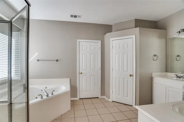 a bathroom with a bathtub and a shower