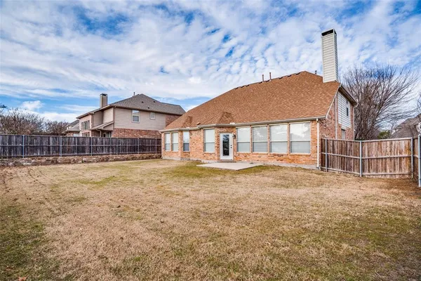 a view of a house with a yard and deck