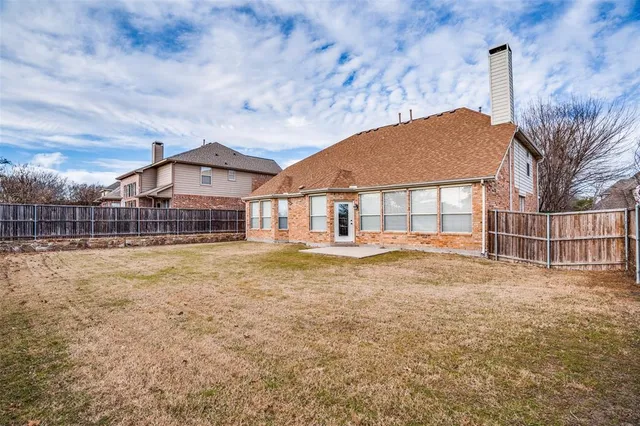 a view of a house with a yard and deck