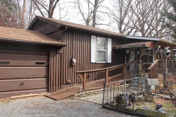 a view of a house with a large window and wooden fence
