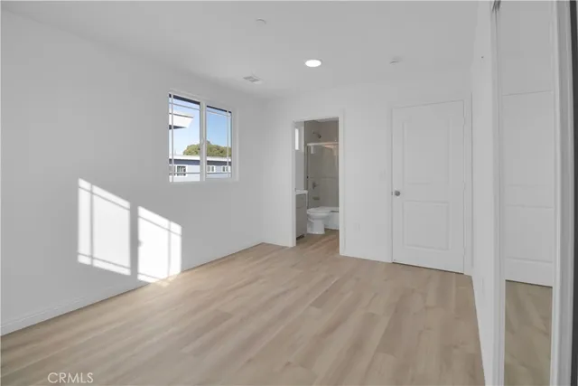 an empty room with windows and closet