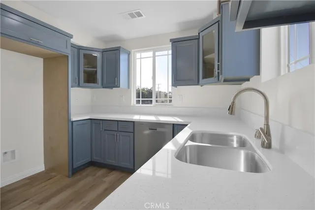 a kitchen with a sink and a large mirror