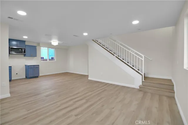 a view of a kitchen with a sink and a stove top oven