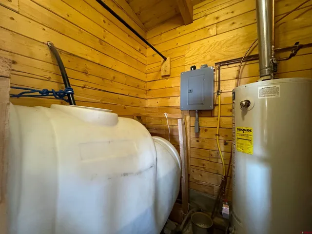 a bedroom with a bed chair and a large window
