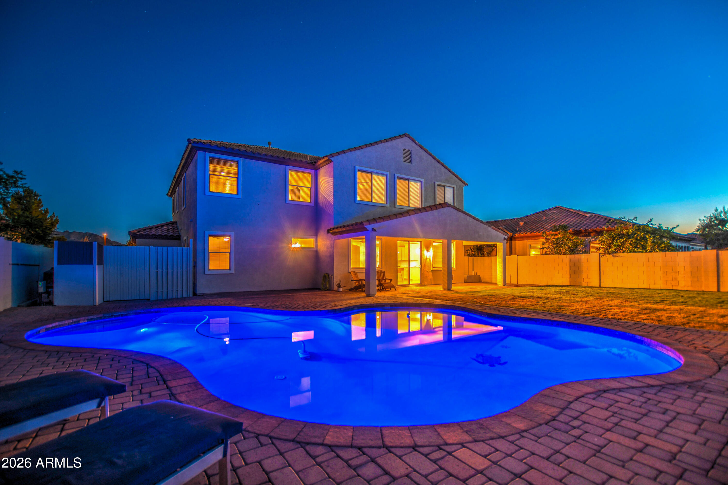 3078 East Muirfield Street Gilbert, AZ 85298 - Photo 88 of 92 a view of a pool with red chairs and table in the patio