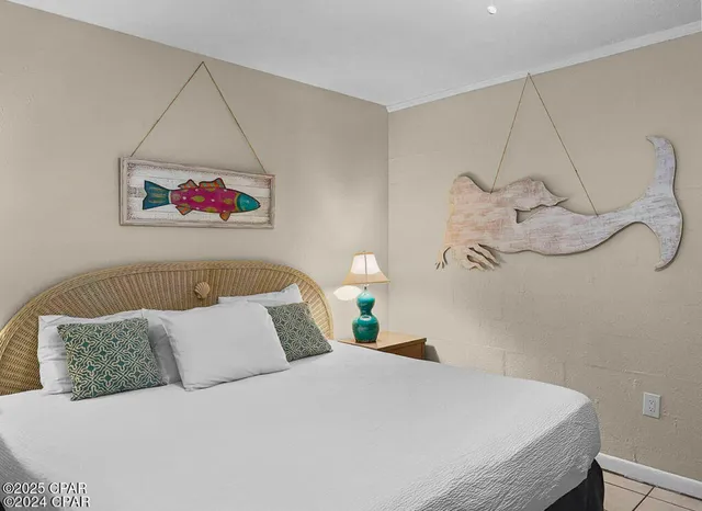 a bedroom with a bed and a painting on the wall