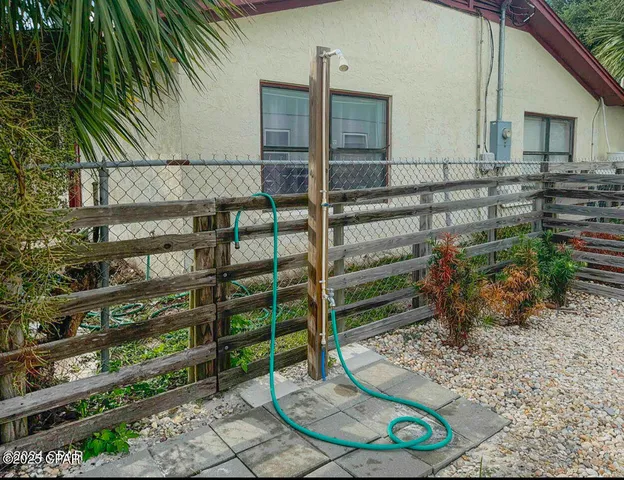 a view of a backyard with plants and outdoor seating