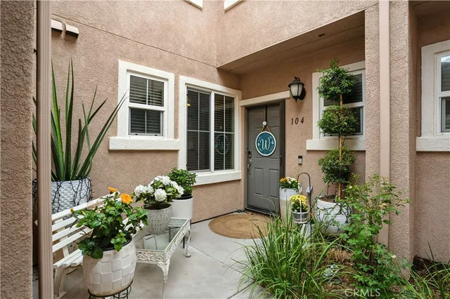 a front view of a house with outdoor seating