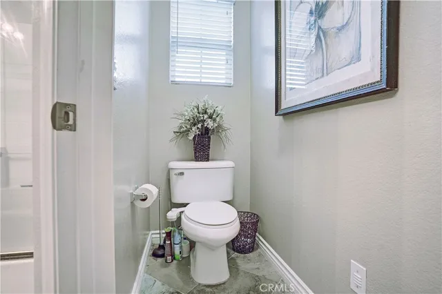 an empty room with a ceiling fan and a window