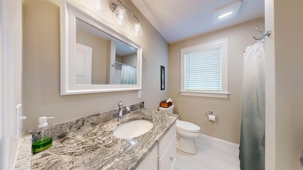287 Wareham Street Middleboro, MA 02346 - Photo 8 of 28 a bathroom with a granite countertop sink toilet and mirror