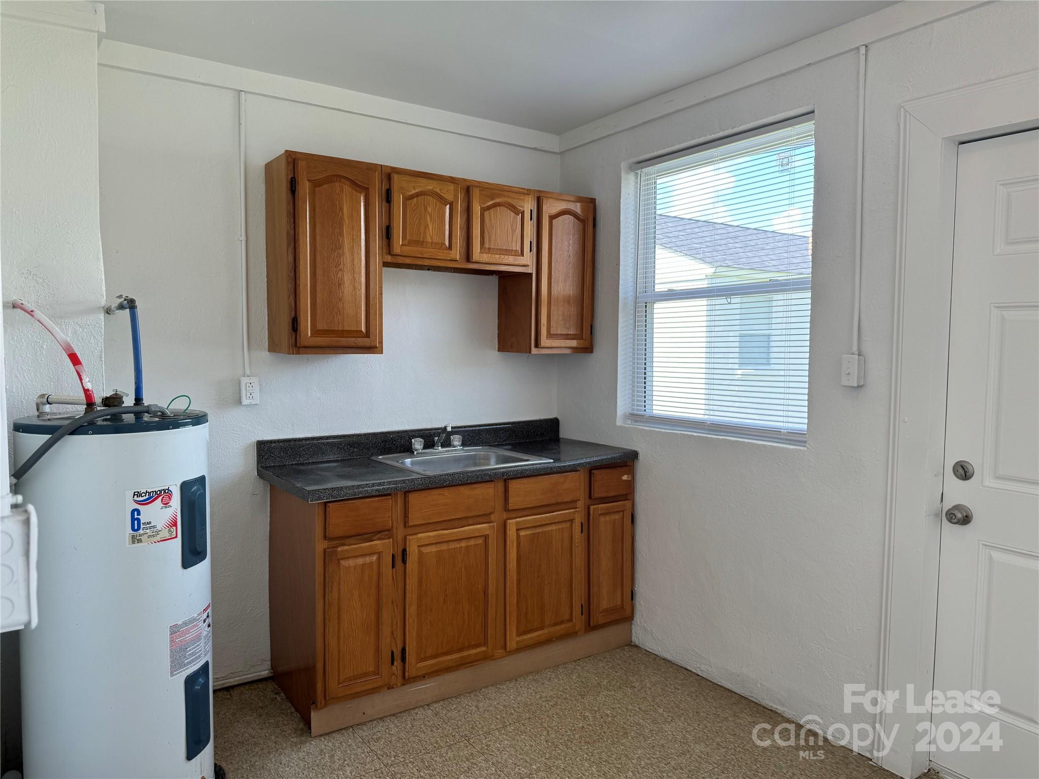 200 York Street, Unit O6 Chester, SC 29706 - Photo 5 of 13 a kitchen with stainless steel appliances granite countertop a stove and a sink