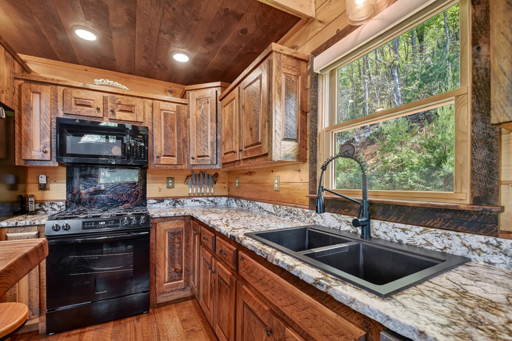459 Quail Ridge Road Epworth, GA 30541 - Photo 13 of 73 a kitchen with a sink a stove and cabinets