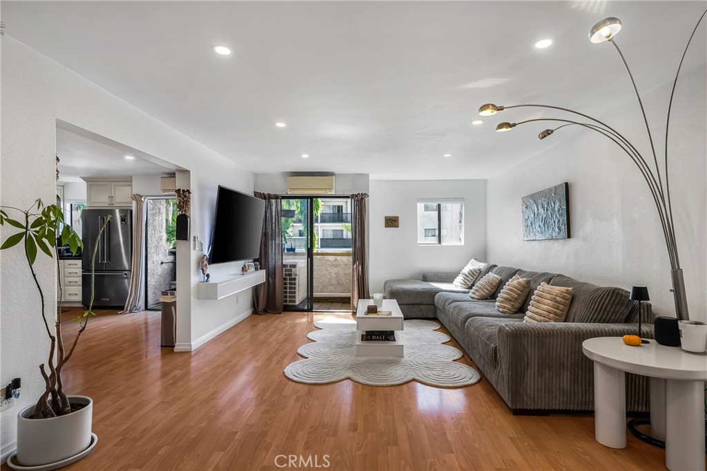 a living room with furniture potted plant and a flat screen tv