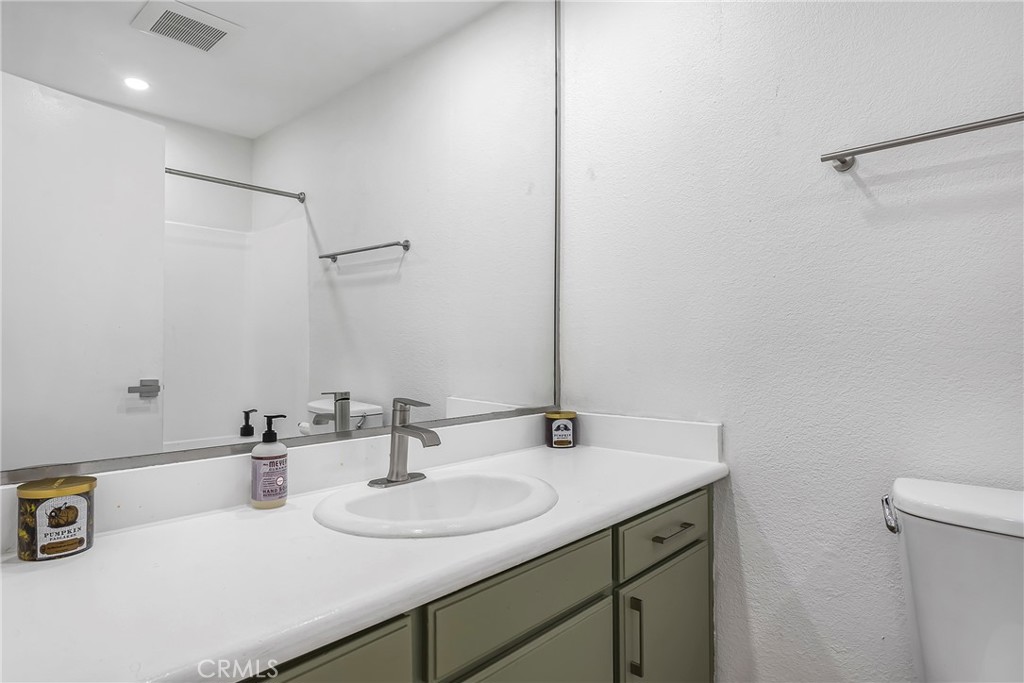 18530 Hatteras Street, Unit 213 Tarzana, CA 91356 - Photo 14 of 17 a bathroom with a sink and a mirror