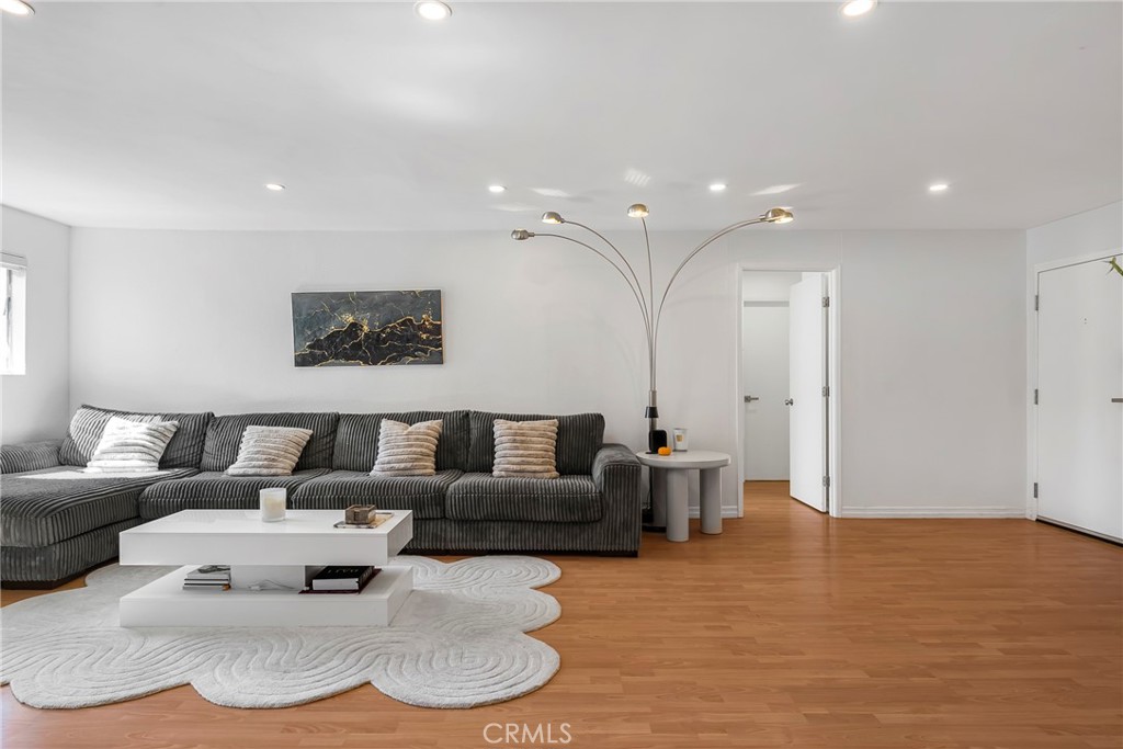18530 Hatteras Street, Unit 213 Tarzana, CA 91356 - Photo 2 of 17 a living room with furniture and a white kitchen