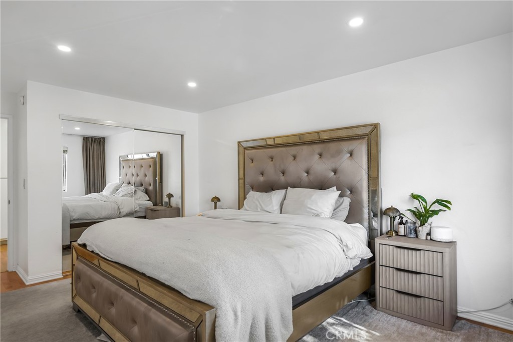 18530 Hatteras Street, Unit 213 Tarzana, CA 91356 - Photo 9 of 17 a bedroom with double bed and a potted plant