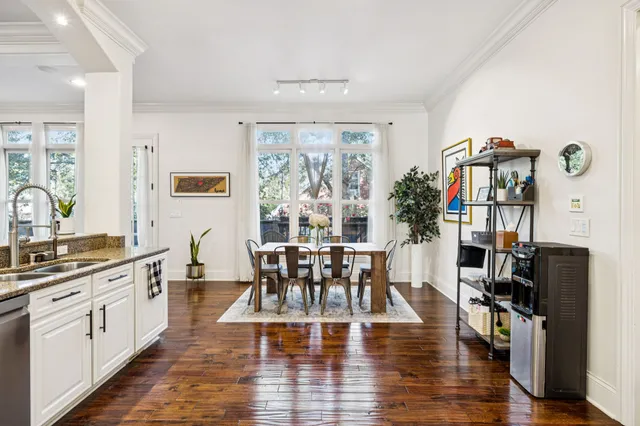 a bedroom with a large bed a flat tv screen and a couch