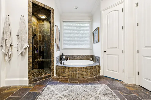 a bathroom with a toilet a sink and wooden floor