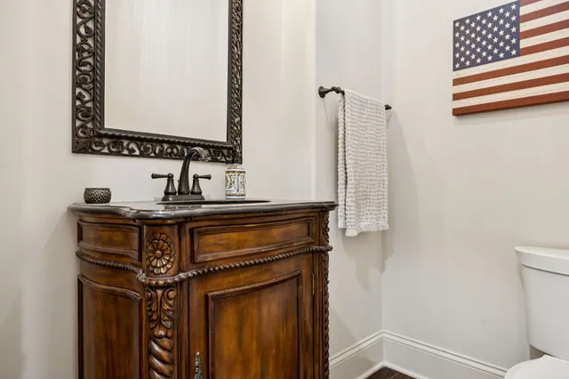 a bathroom with a tub a sink and a large mirror