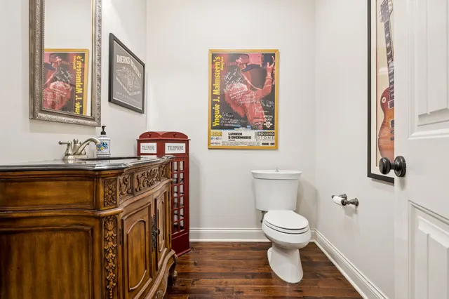 a bathroom with a sink a toilet a mirror a bathtub and shower